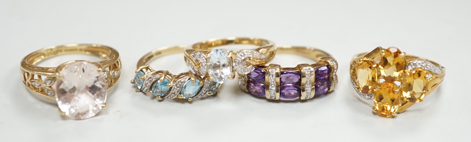 Five assorted modern 9ct gold and gem set dress rings, including citrine and diamond and amethyst and diamond, gross weight 14.8 grams.